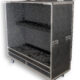Guitar Vault | G.O.M.C. Flight & Road Cases Open, foam-lined equipment case on wheels, showing interior rack with black foam blocks for gear protection.